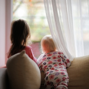 two children watching at the window