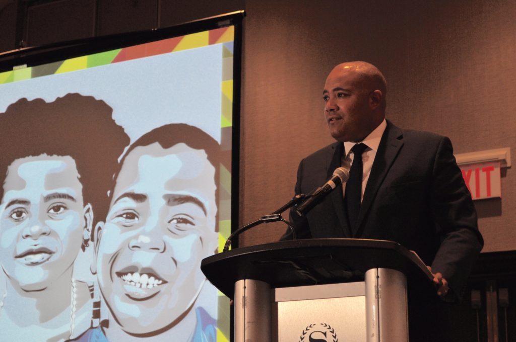 Minister Coteau addressing the Symposium attendees