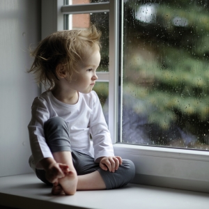 child looking out a window