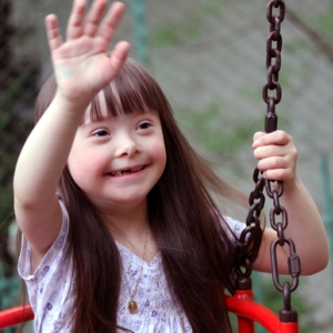 girl on a swing, waving