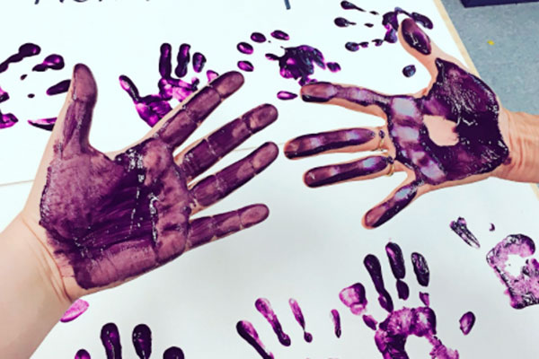 Hands with purple paint photo