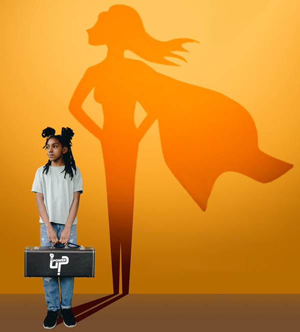 Photo of young girl with her shadow in the shape of a super hero with a cape