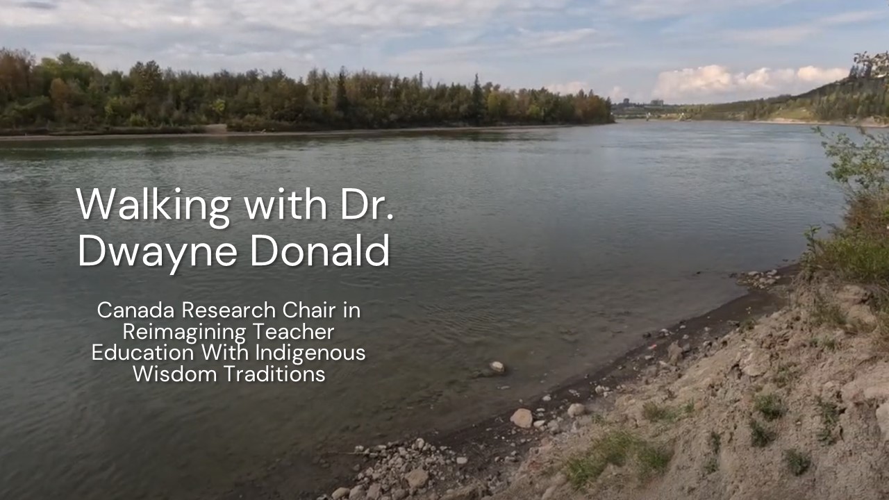 Picture of a riverbank with the text "Walking with Dr. Dwayne Donald, Canada Research Chair in Reimagining Teacher Education With Indigenous Wisdom Traditions"